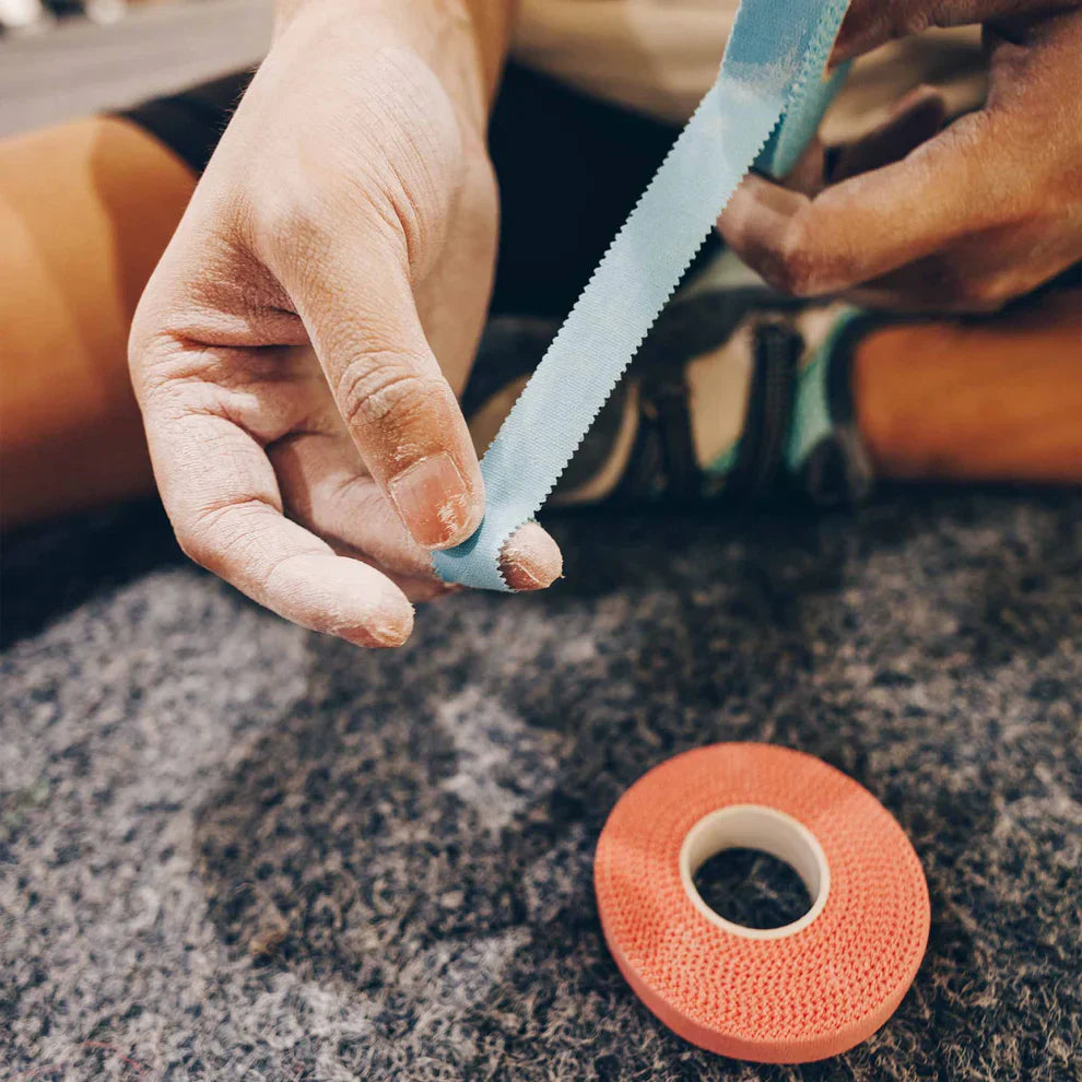 Climber putting tape onto their finger