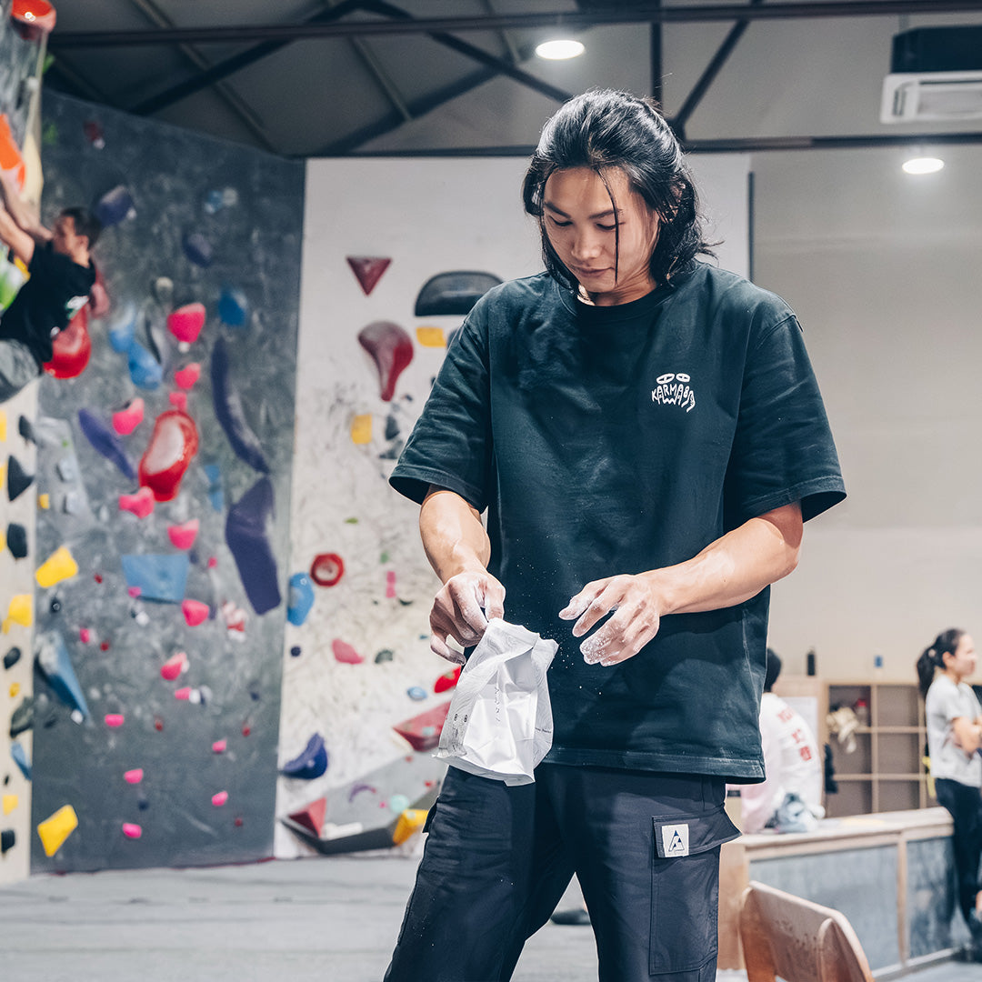 Climber using KUMO chalk in a humid indoor gym
