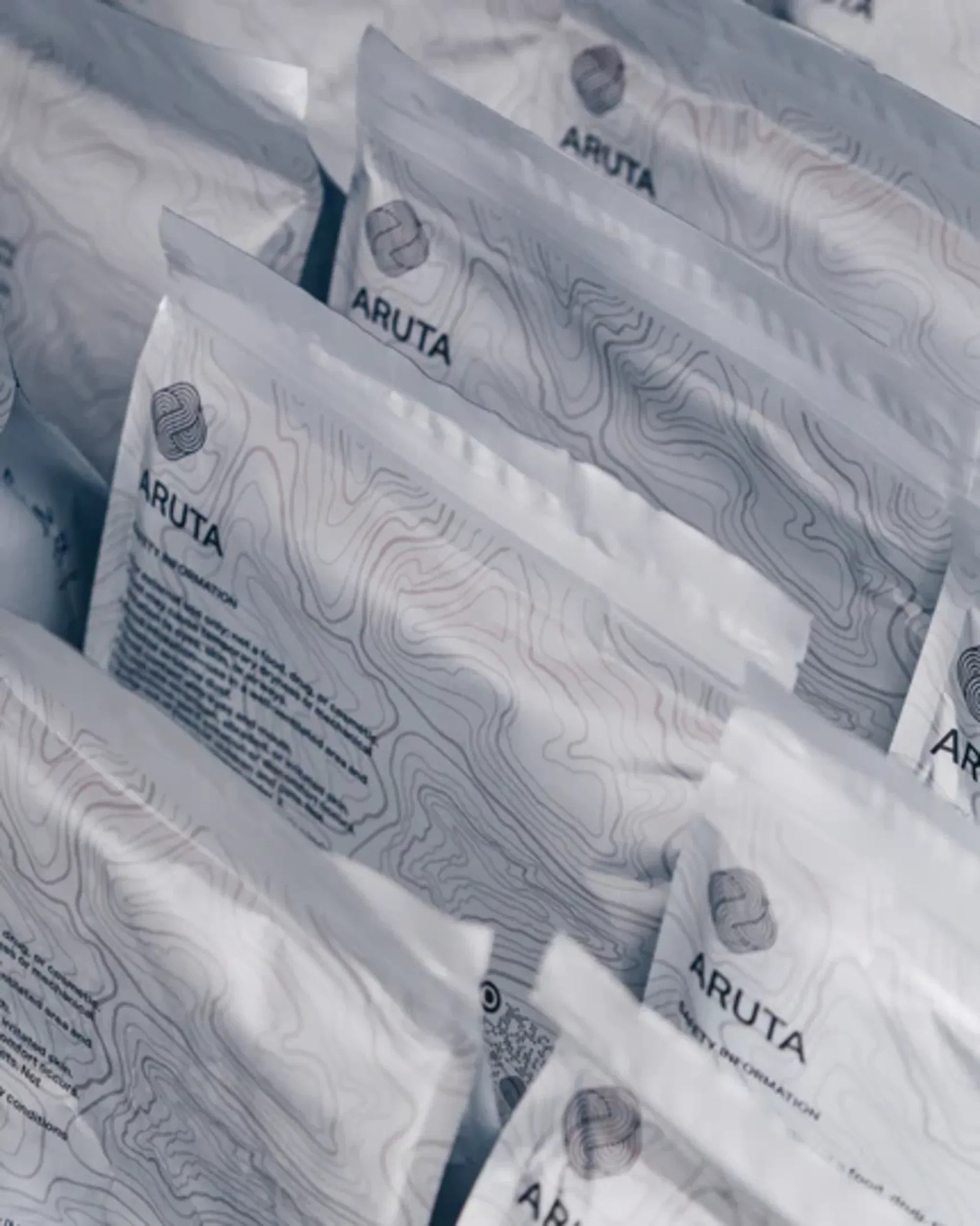 Multiple Aruta Kumo chalk bags lined up showing topographic packaging design