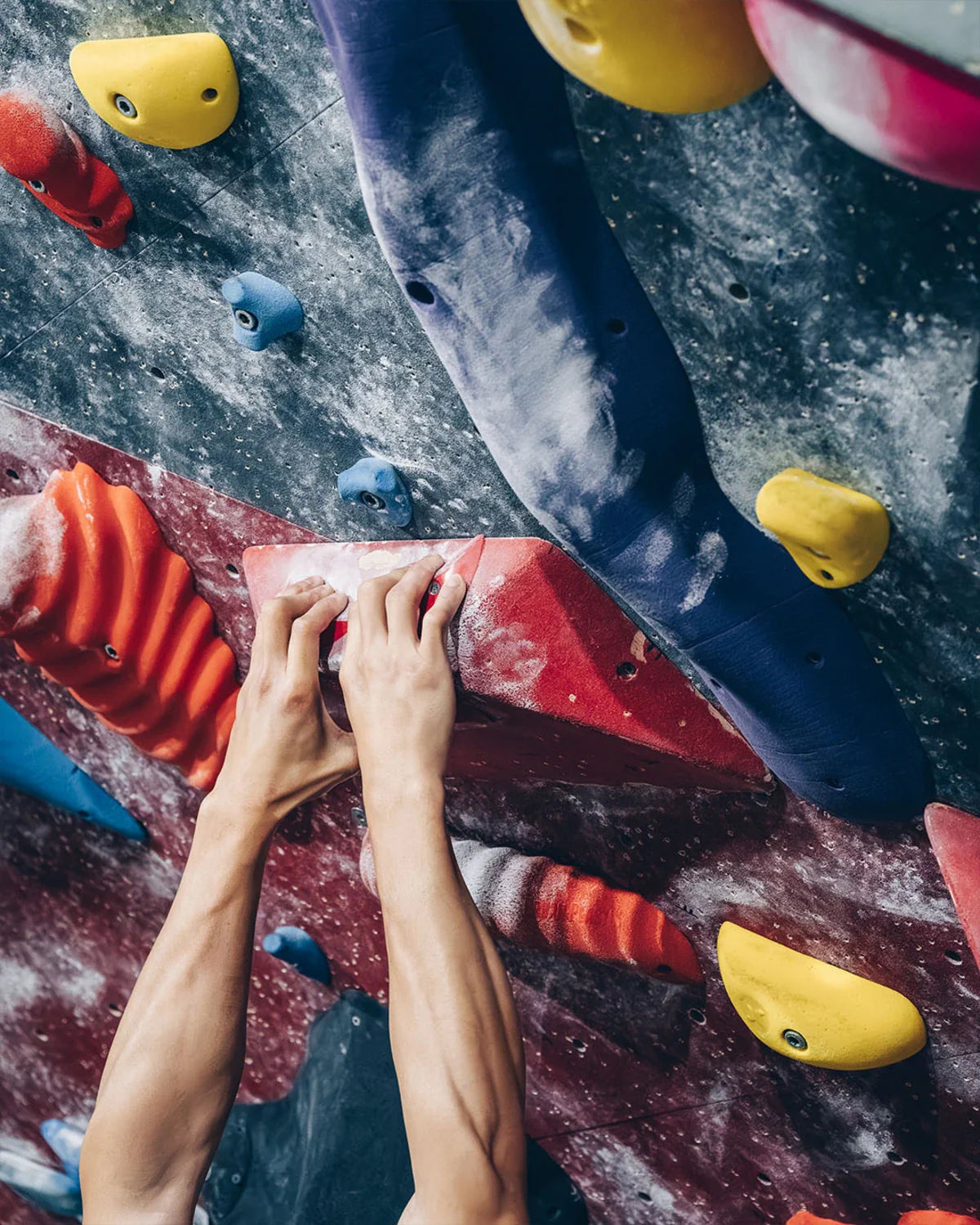Climber holding on to slopy crimps with both hands